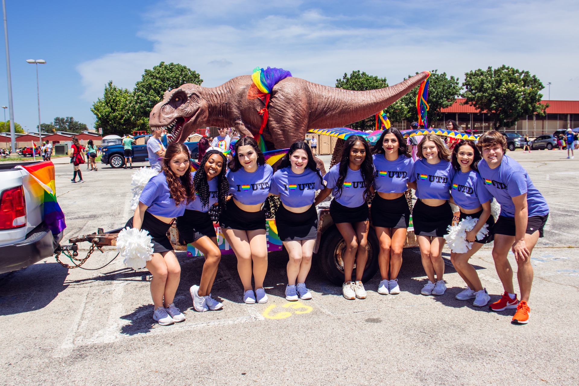 The UTD Cheer Squad Poses Next to a Pride Parade Float