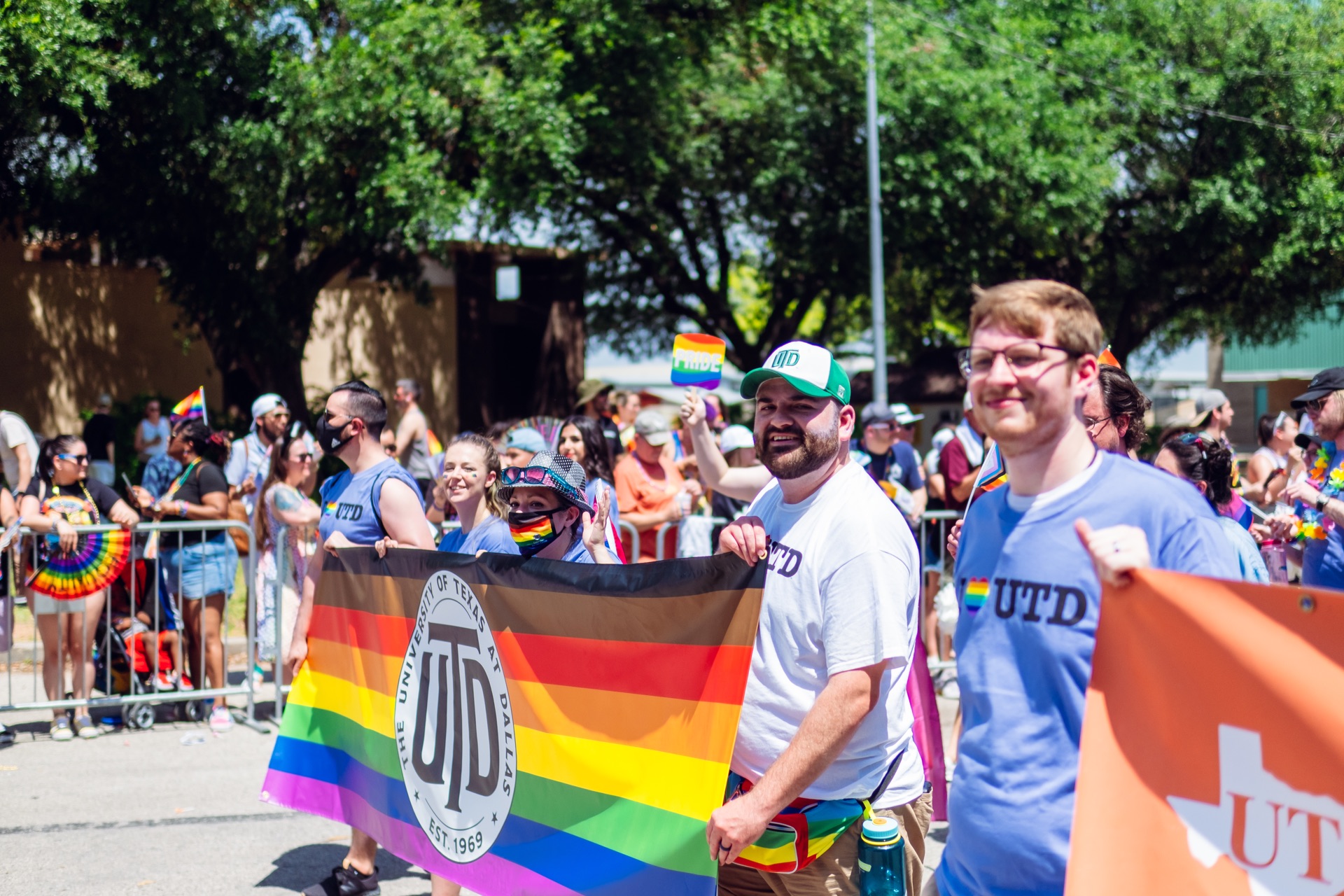 The UTD Dallas Pride Parade Marchers Holding Up Banners